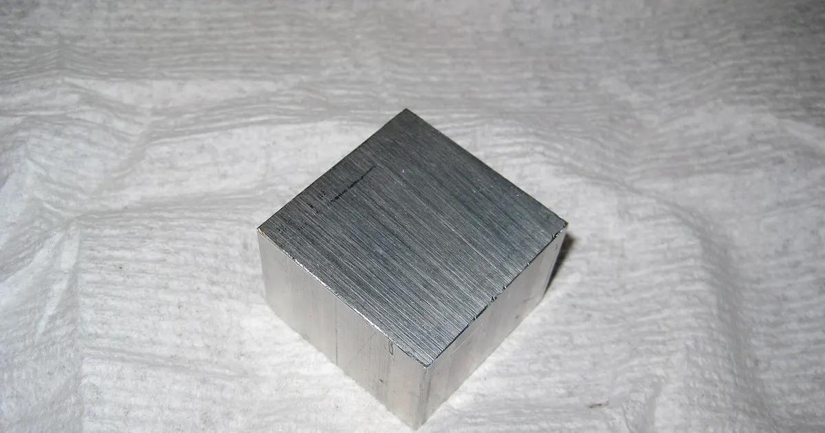Solid block of aluminum with sawn faces, a thick section of the kind machined from 7050 or 7075 plate